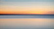 © Tim Booth Photography/Stocksy - Blurred sunset over the sea.