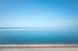 © Tim Booth Photography/Stocksy - Calm blue sea and shoreline