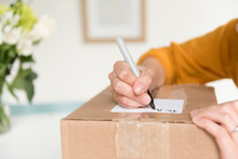 Woman Writing Address On Package