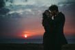 © Yura Shevchenko/Stocksy - kissing on the cliff