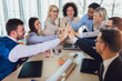 © Mediteraneo - Large business team showing unity with their hands together. Selective focus