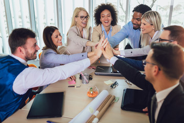 Large business team showing unity with their hands together. Selective focus