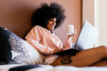 Beautiful afro woman using the laptop