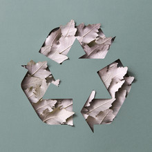 Gray Triangular Sign Of Leaves And Dark Grey Cardboard With Copy Space. Eco Recycling Symbol. Flat Lay