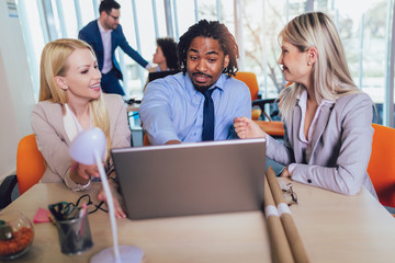 Wall Mural -  Group of young business people working together in creative office. Selective focus.