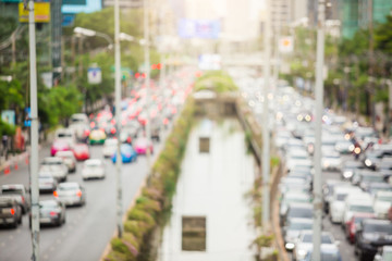 Wall Mural - Blurred photo of Sathorn road and traffic in Bangkok. Blur of traffic light on the main road and lighting background.