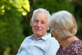 Fototapeta  - Old man and woman talking in park
