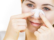© Voyagerix - Woman applying pore strips on nose
