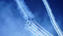 Airshow In Sky By Bright Sea And Traced Lines
