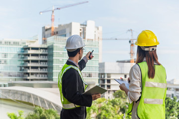 Civil Engineers At Construction Site and A land surveyor using an altometer