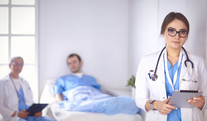 Wall Mural - Doctor checking heart beat of patient in bed with stethoscope