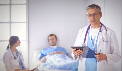 Wall Mural - Doctor checking heart beat of patient in bed with stethoscope