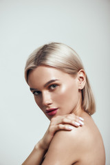 perfection. vertical photo of sexy young woman with blond hair and perfect shiny skin looking at cam