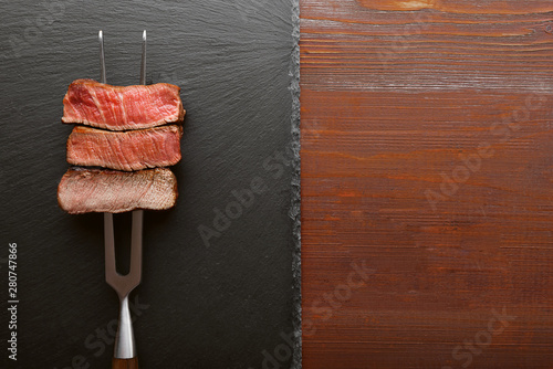 Cuadros en Lienzo Three pieces of meat on a fork for meat