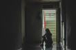 © TeTe Song - Silhouette of girl sitting alone in the dark,Sad and Serious women sitting hug his knee alone of old condo, Domestic violence, family problems, The concept of depression and suicide with copy space