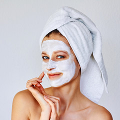 Wall Mural - beautiful woman applying facial mask on her face. skin care and treatment, spa, natural beauty and c