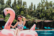 Smile asian young woman on pink inflatable.