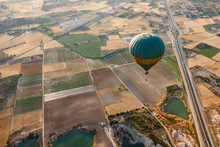 View Of A Balloon Hovering Over Fields, Road, Lakes.