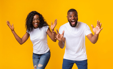 Wall Mural - Shocked afro couple with hands wide open