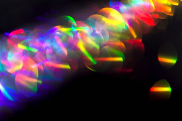 Wall Mural - Multicolor beautiful bright neon lights flares and trails lines in motion on isolated black background. Bokeh lens flare glow. Festive backdrop