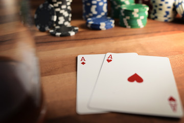 Poker Chips with Playing Cards on a Beautiful Wooden Table