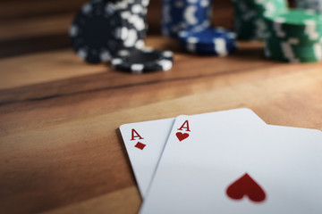 Poker Chips with Playing Cards on a Beautiful Wooden Table