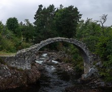 Stone Bridge In Scotland With A River Underneath It 