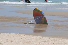 Discarded Umbrella On Beach
