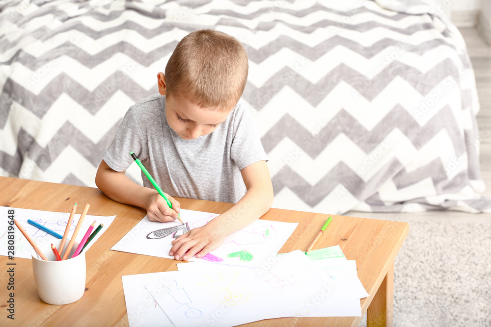 Little boy drawing at home