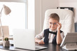 © Pixel-Shot - Cute little businessman in office