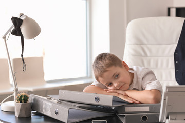 Tired little businessman in office