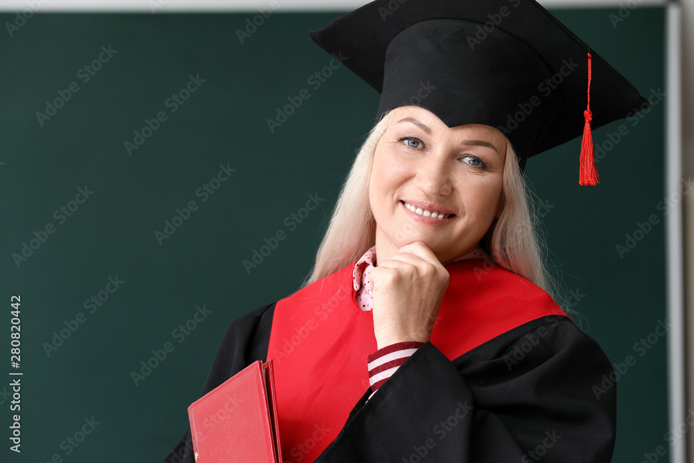 Mature woman in bachelor robe in university