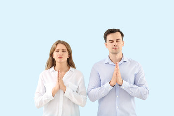 Sticker - Religious couple praying to God on light color background