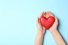 Woman Holding Heart On Blue Background, Top View With Space For Text. Donation Concept