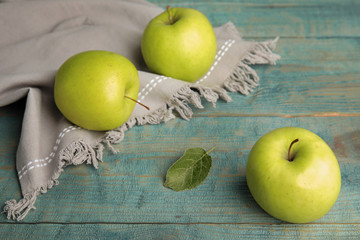 Fresh ripe green apples on blue wooden table