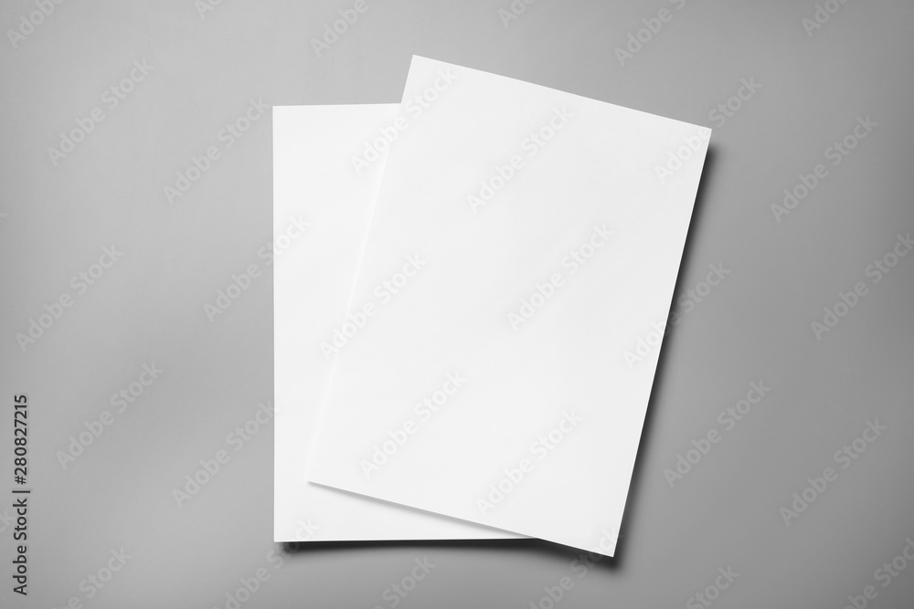 Blank paper sheets for brochure on grey background, top view. Mock up - obrazy, fototapety, plakaty 