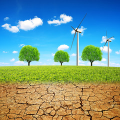 Wall Mural - Wind turbines on meadow and dry country with cracked soil. Concept of change climate or global warming.