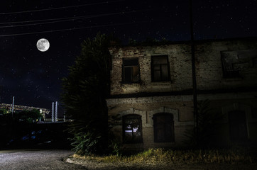 Wall Mural - full moon over quite village at night. beautiful night landscape of old town street with lights. rus