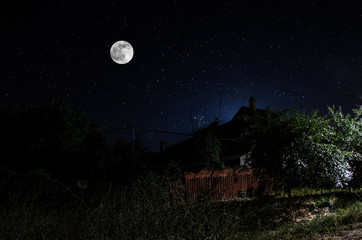 Wall Mural - full moon over quite village at night. beautiful night landscape of old town street with lights. rus