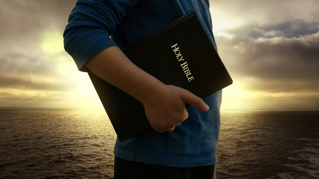 person carrying a Bible at his side