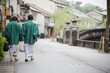 Japanese woman couple wearing kimono and walking at Kinosaki Onsen village street in Toyooka City, Hyogo, Japan. See from back side in morning. Japan traveler trip.