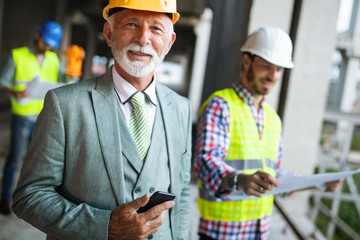 Construction engineer with foreman worker checking construction site