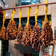 A Collection Of Ripe Dates Hanging For Sale In A Tunisian Market. 