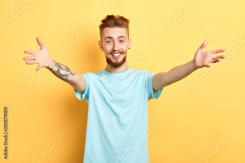 Young Handsome Cheerful Man Wearing Blue T Shirt Standing With Open Arms For Hug Over Isolated Yellow Background Welcome To A Barbershop Close Up Portrait Happiness Emotion And Feeling Stock Photo Adobe