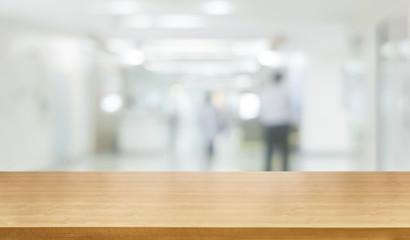 Wood table in modern hospital interior with empty copy space on the table for product display mockup. Medical and healthcare concept.