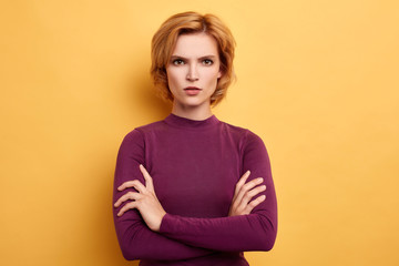 Angry annoyed youngwoman keeping arms crossed and staring at camera with sceptical and distrustful look Human facial expressions. close up portrait