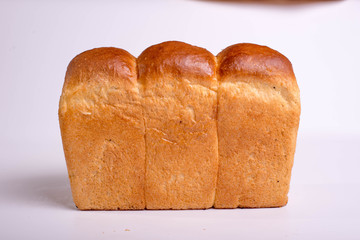 A loaf of bread on a white background. Baked delicious bread isolated