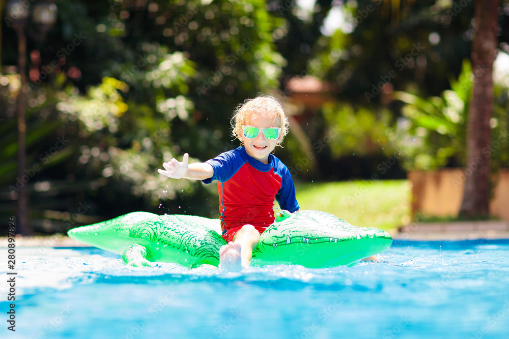Child in swimming pool. Kid on inflatable float Stock Photo | Adobe Stock
