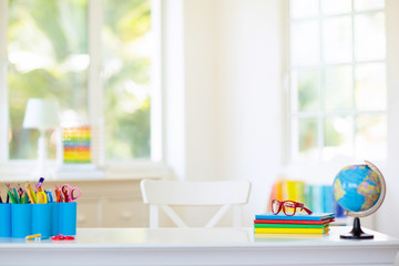 Back to school. Kids desk with books, globe.