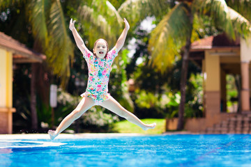 Child in swimming pool. Summer vacation with kids.